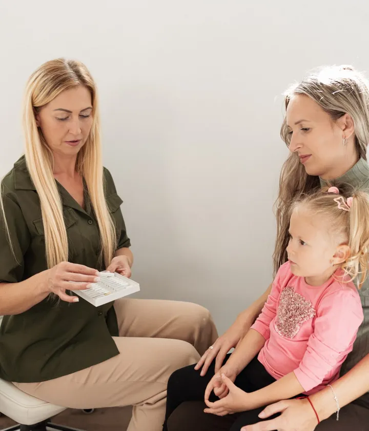 Michaela Schön erklärt einer Familie den Ablauf einer Sitzung